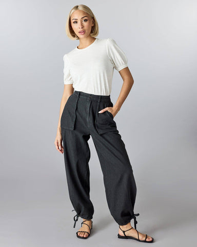 black cotton pants with front patch pockets and tie at the ankle