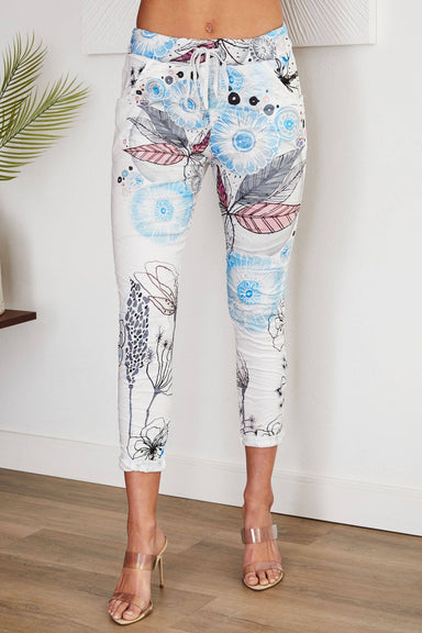 magic pants with white background and floral print